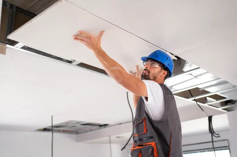 Man installing drywall