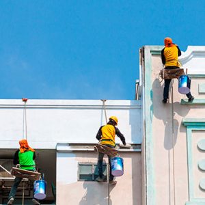 workers-painting-tall-commercial-building